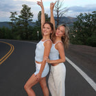 Girls standing in the road wearing blue tank tops